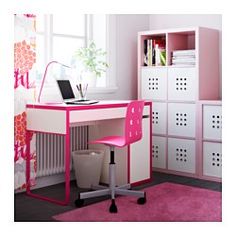 a pink and white desk with a laptop on it