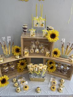 sunflowers and cupcakes are arranged on display