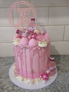 a birthday cake with pink frosting and decorations