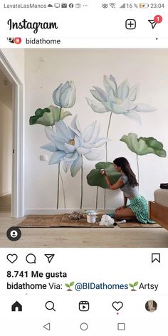 a woman painting flowers on the wall with watercolors in front of her and an instagram post below