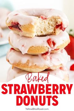 strawberry donuts stacked on top of each other with icing and strawberries in the background