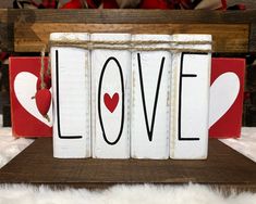 two wooden blocks with the word love painted on them