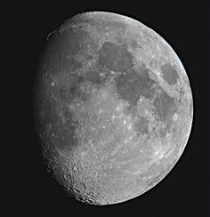 the moon is shown in black and white with some light on it's side