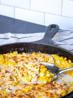 a skillet filled with cheese and corn