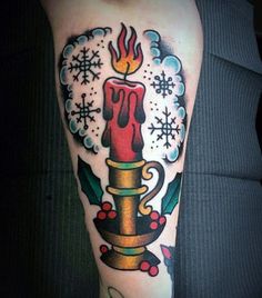 a tattoo with a candle and snowflakes on it