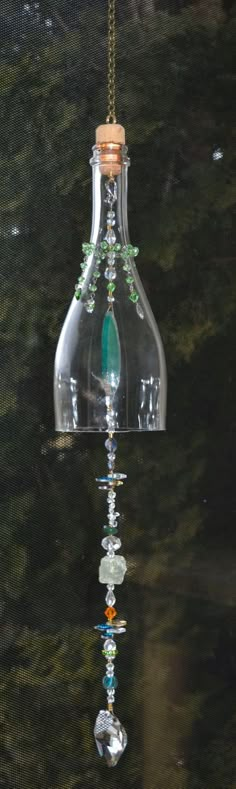 "wine bottle suncatcher mobile chime glass crystal heart art recycled retro with up to date feel with agate, stone, crystals. length from top of hanging ring to bottom of last ring approx. 28\", large crystal heart is approx. 1 3/4\" wide, crystals throw tiny sparkles when light hits then just right. lovely addition to a porch overhang, or inside a window. no fishing line, we use strong coated steel.  a great upcycled piece of art" Bottle Suncatcher, Wine Bottle Chimes, Suncatcher Mobile, Bottle Chimes, Porch Overhang, Wine Bottle Lanterns, Wind Chimes Craft