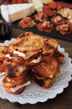 some toasted sandwiches are stacked on a plate