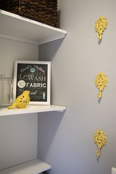 the shelves in this bathroom are decorated with yellow decorations