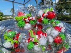 christmas ornaments are sitting on a glass plate