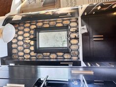 a stove top oven sitting inside of a kitchen next to a wall with pictures on it