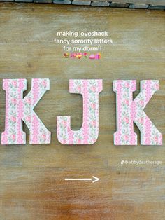 the word kjk is made out of fabric and has pink flowers on it