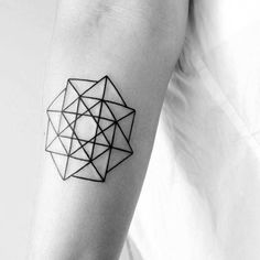 a black and white photo of a person's arm with a geometric tattoo on it