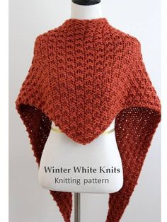 an orange knitted shawl on a mannequin with the words winter white knits knitting pattern