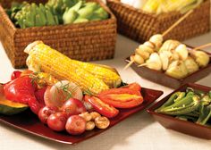 several different types of vegetables on red plates