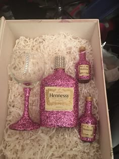 pink glittered wine glasses and bottles in a box