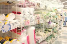 there are many different types of toilet paper on the shelves in this store that is filled with rolls of toilet paper