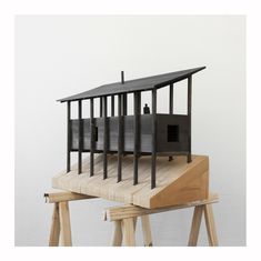 a model of a house sitting on top of a wooden table