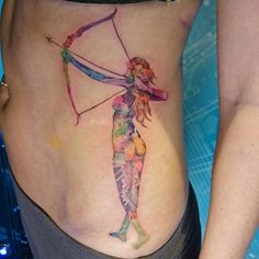 a woman's stomach with a watercolor drawing of a girl holding a bow and arrow