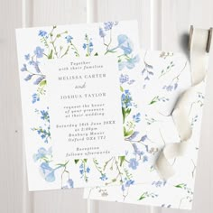 two wedding cards with blue flowers on them