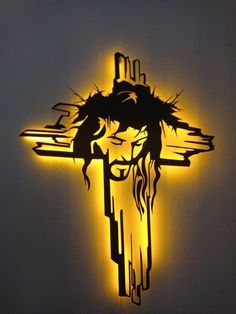 a lighted cross with the image of jesus on it