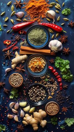 an assortment of spices and herbs arranged on a table with blue background, top view