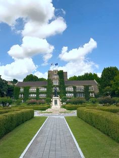 a large building surrounded by hedges and trees