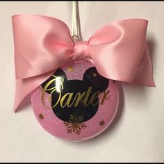 a minnie mouse ornament with a pink bow on it's head and name