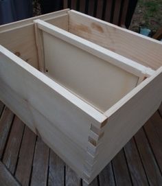 a wooden box sitting on top of a wooden deck