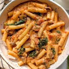 a white bowl filled with pasta and sauce