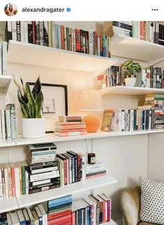 a bookshelf filled with lots of books next to a lamp