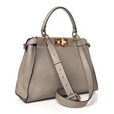 This is an authentic FENDI Vitello Seta Plexiglass Tortoise Medium Peekaboo Iconic Satchel in Tortora. This chic tote is finely crafted of soft taupe grey calfskin leather. This bag features a gold metal and tortoiseshell resin squared turn-lock on either side of the looping top handle that open to a microfiber interior with a zipper pocket. It can be carried as a shoulder bag with the optional strap or as a tote by the handle. Fendi Peekaboo Bag, Fendi Tote Bag, Fendi Tote, Fendi Shoulder Bag, Fendi Peekaboo, Taupe Grey, Python Print, Boston Bag, Shopper Tote