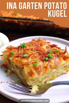 a close up of a plate of food on a table with a fork in it