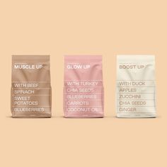 three bags of muscle up on a pink and beige background, with the words'muscle up'in white lettering