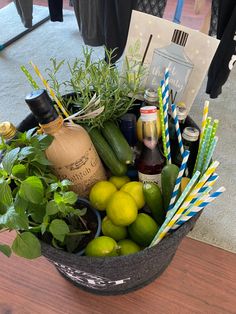 a basket filled with lemons, cucumbers and drinks