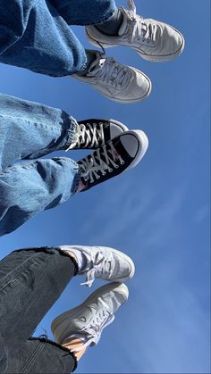 three people standing in the air with their feet up