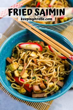 two bowls filled with noodles and vegetables on top of a table next to chopsticks