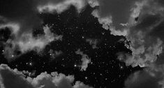 black and white photograph of clouds in the night sky