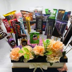 an arrangement of candy, candies and chocolates in a gift box