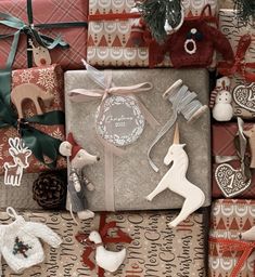 presents wrapped in brown and white wrapping paper with christmas decorations on them, including an ornament