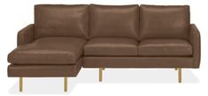 a brown leather sectional sofa with gold legs