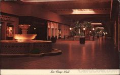 the lobby is lit up with candles and water fountain in it's centerpiece