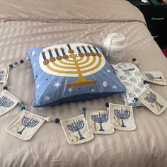 a bed topped with pillows covered in hanukkah decorations