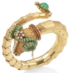 Designed as a ram, with a fully flexing, bypass body of textured 14k gold, the head and tail accented with round diamonds weighing approximately 1.05 carats total, an oval cabochon emerald, round rubies and seed pearls dangling from green enamel horns, inner circumference 6 in. Enamel Bangle, Flexing, Seed Pearl, Green Enamel, Oval Cabochon, Earring Necklace, Ring Necklace, Bangle Bracelet, Round Diamonds