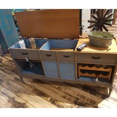 an old dresser is turned into a wine rack with drawers and storage compartments for bottles