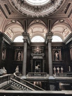 the inside of a building with many statues on it's walls and a domed ceiling