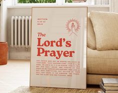 the lord's prayer is displayed in front of a couch with books on it