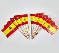 five matches are lined up in the shape of spain's flag, which is yellow and red