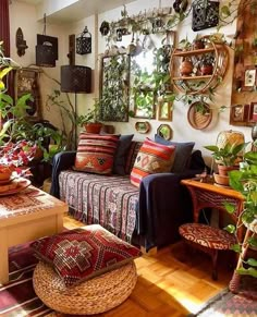 a living room filled with furniture and lots of plants