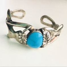 Vintage Sterling Silver Tested Sand Cast Style Cuff Featuring Polished Sleeping Beauty Genuine Turquoise Stone With Leaf Motif And Swirling Band. This Bangle Is In The Traditional “Sand Cast Style” Navajo Silversmith Techniques Dating Back To Late 1800’s Involves Casting Jewelry Made From Stone Molds With Designs Made By The Family Several Generations Earlier. This Made This Style Very Consistent In Quality, Strong And Substantial. One Of The First Traditional Navajo Silversmith Styles. No Hallmark Item Is Size Adjustable But Very Solid So Changing Size Takes Some More Opening, Currently For A Size 6-7 Inch Wrist. Lots Of Patina And Rubbing On This Bracelet Please Refer To Photos Fo Silversmith Techniques, Stone Molds, Wrist Jewelry, Sand Casting, Leaf Motif, Casting Jewelry, Genuine Turquoise, Turquoise Stone, Vintage Sterling Silver