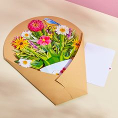 a bouquet of flowers in a brown envelope